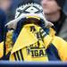 Michigan fan Tasha Coleman, of Saginaw, attempts to stay warm during her first visit to the Big House at the annual alumni flag football game before spring practice at Michigan Stadium on Saturday, April 13, 2013. Melanie Maxwell I AnnArbor.com